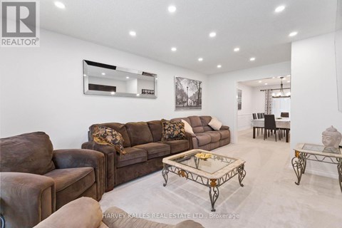 A living room with a brown couch and a coffee table.