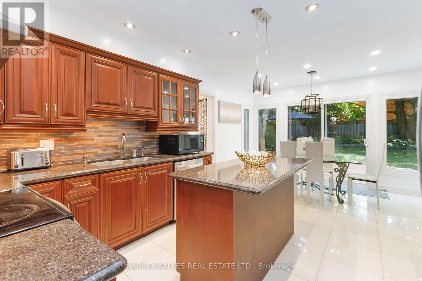A kitchen with wooden cabinets and a granite countertop.