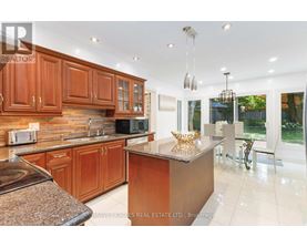 A kitchen with wooden cabinets and a granite countertop.
