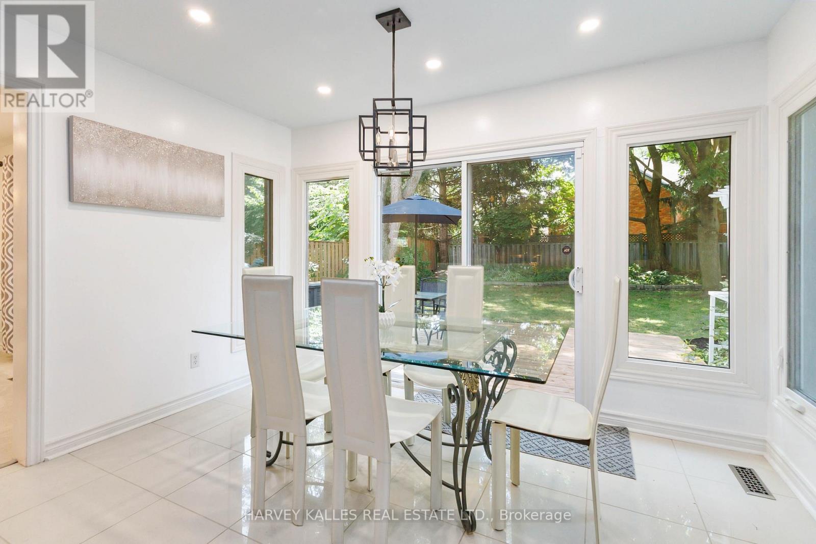 A dining room with a glass table and chairs.