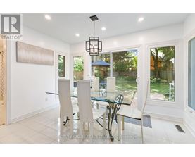 A dining room with a glass table and chairs.