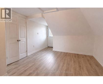 A room with a white door and a window with a white wall.