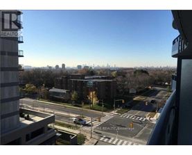 A view from a high-rise building looking out over a cityscape with a clear blue sky.
