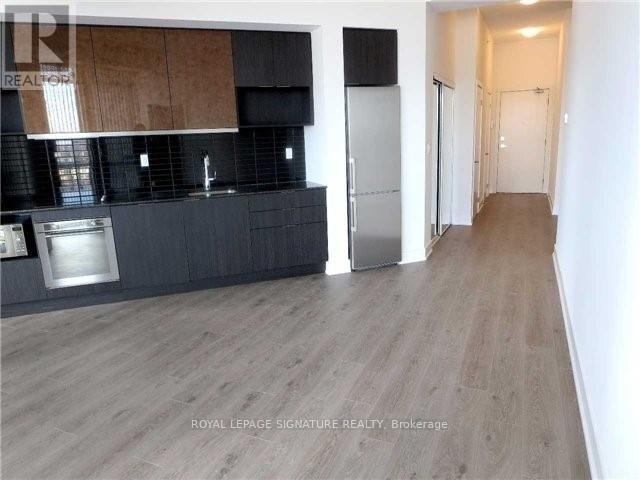 A kitchen with a refrigerator and a countertop.