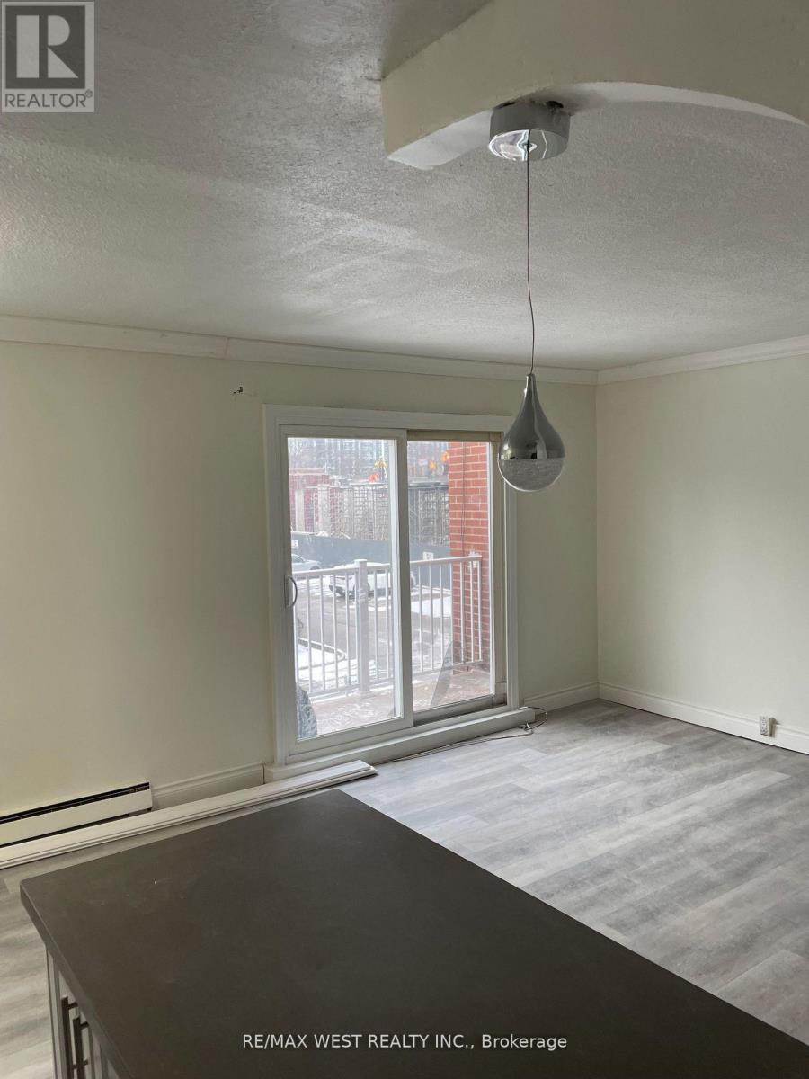 A room with a table and a window with a view of a building.