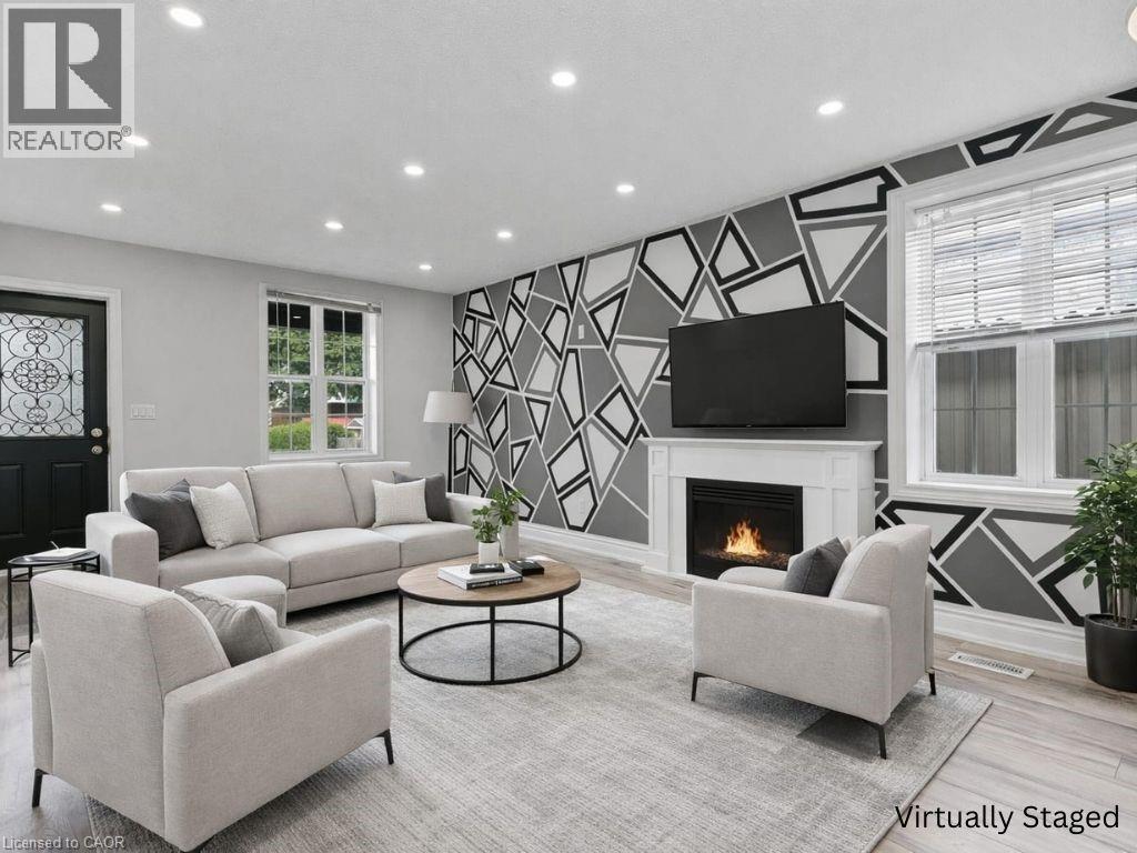 A living room with a fireplace and a television on the wall.