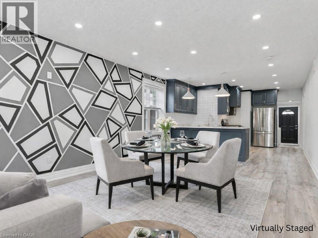 A modern dining room with a geometric wall design and a glass table.