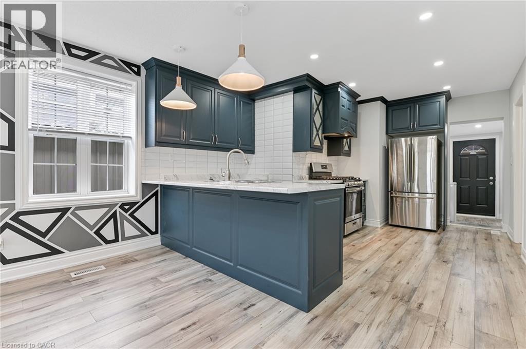 A kitchen with dark green cabinets and a white countertop.
