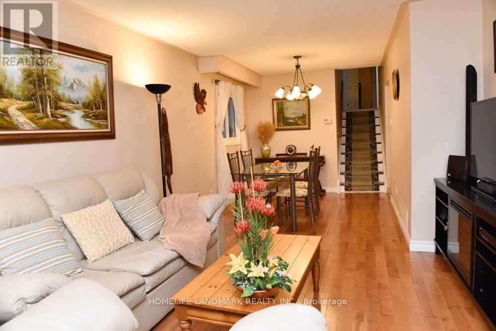 A living room with a couch, coffee table, and a painting on the wall.