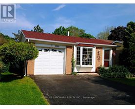A house with a white garage door is for sale.