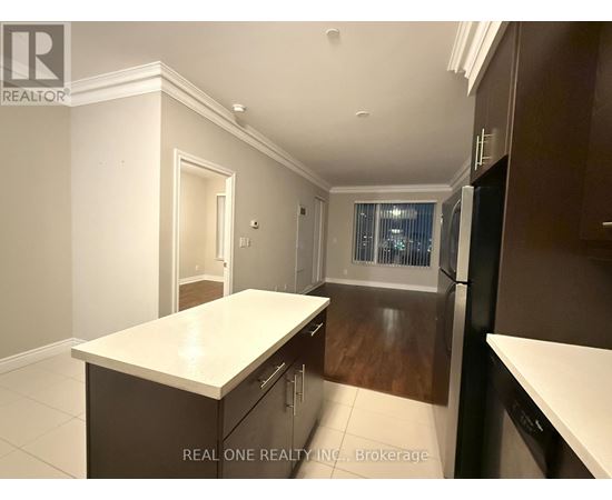 A kitchen with dark wood cabinets and a white countertop.
