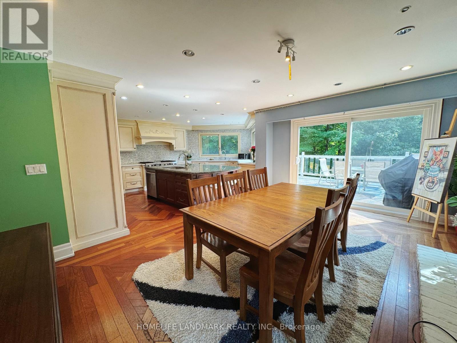 A dining room with a wooden table and chairs.