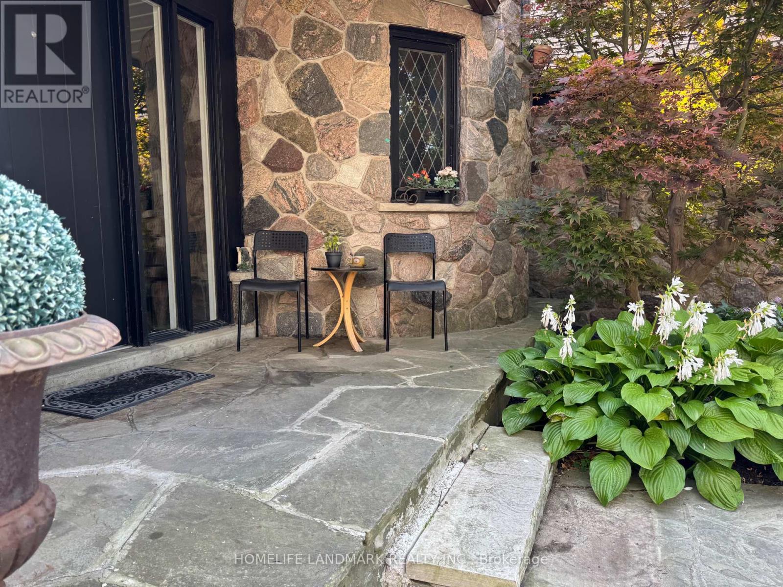 A stone building with a window and a door.