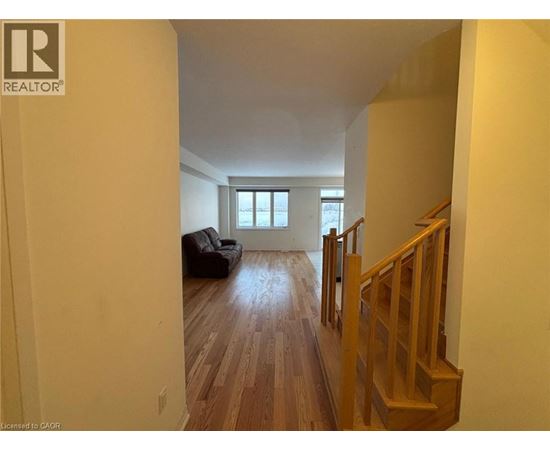 A living room with a couch and a window.