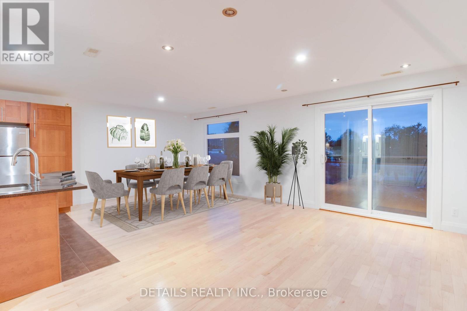 A dining room with a table set for six with a view of the backyard.