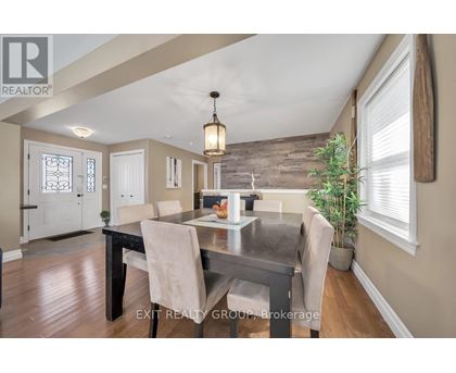 A dining room with a table set for four.