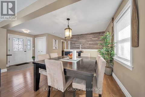 A dining room with a table set for four.