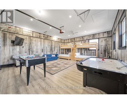 A billiards room with a pool table and air hockey table.