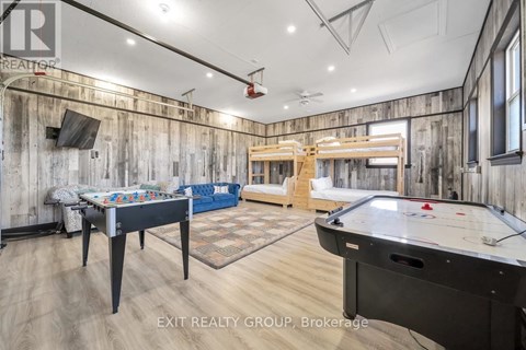 A billiards room with a pool table and air hockey table.