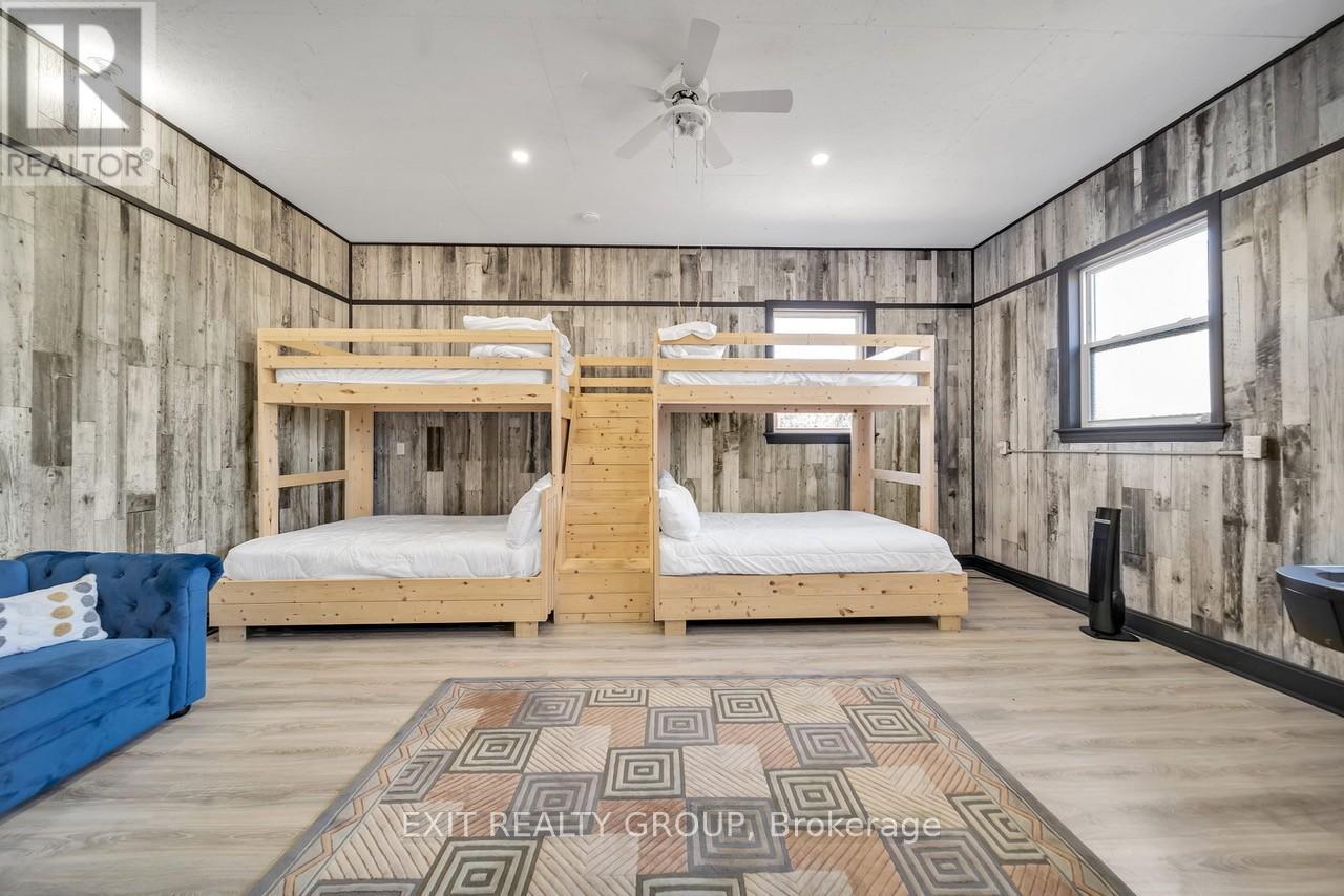 A bedroom with two bunk beds and a blue couch.