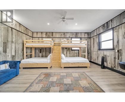 A bedroom with two bunk beds and a blue couch.