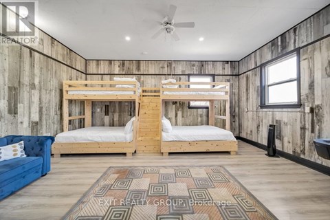 A bedroom with two bunk beds and a blue couch.