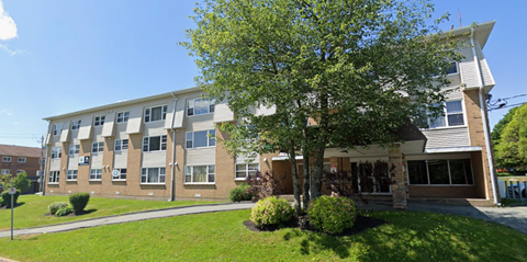 A large building with a tree in front of it.