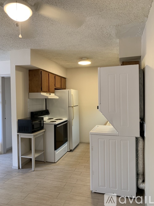 A kitchen with a white refrigerator and a microwave oven.
