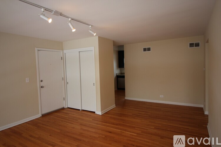 A room with wooden floors and white doors.