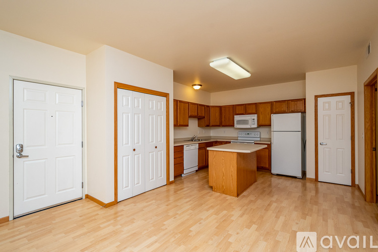 A kitchen area with a white fridge, microwave, and oven.