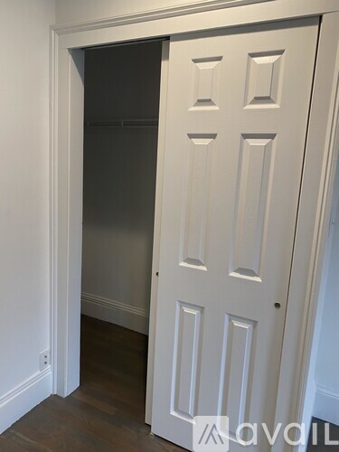 A white door with a small square window in the middle.