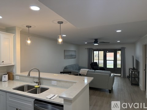 A kitchen with white cabinets and stainless steel appliances.