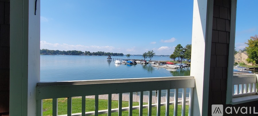 A view from a balcony overlooking a lake with boats.