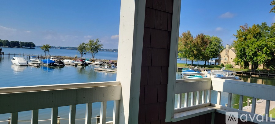 A balcony overlooks a marina with boats docked in the water.