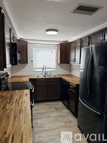 A kitchen with a dining table and chairs in the foreground.