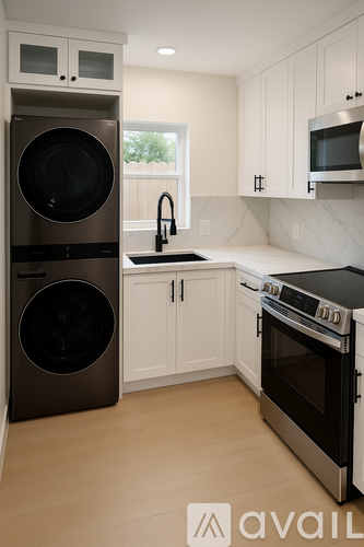 A kitchen with a stainless steel refrigerator and oven, and a white countertop.
