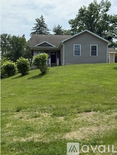 A house with a lawn in front of it.