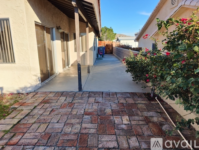 A long brick walkway leads between two buildings.