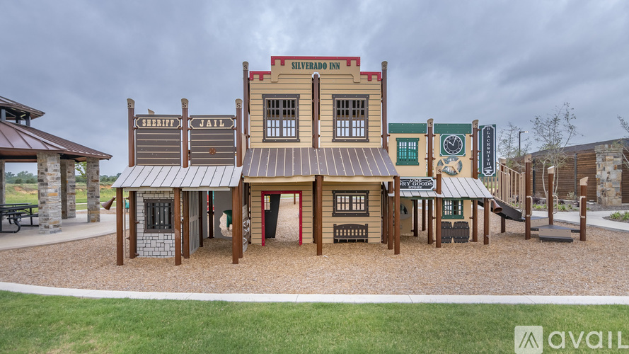 A playground with a wooden structure labeled Silverado Inn.