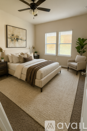 A bedroom with a large bed and a ceiling fan.