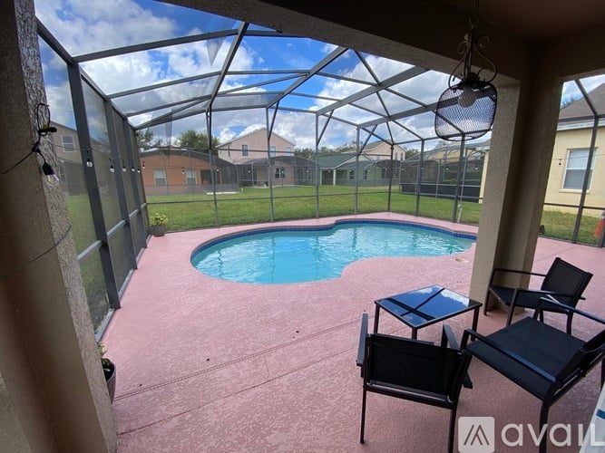 A pool in a backyard with a glass enclosure.