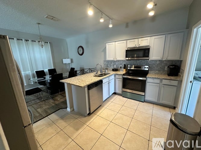 A kitchen with a table and chairs in the middle of the room.