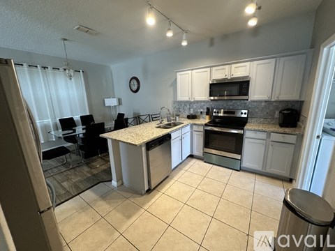 A kitchen with a table and chairs in the middle of the room.