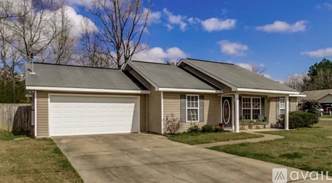 A house with a garage door that is open.