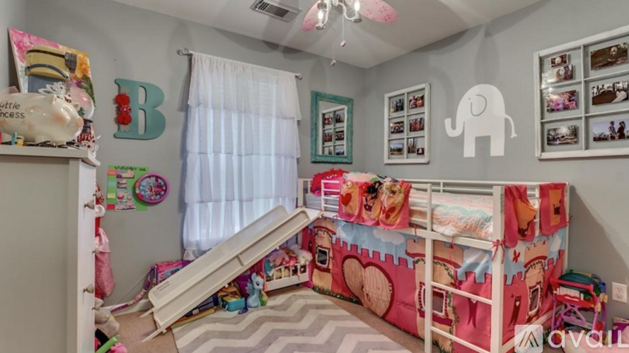 A child's bedroom with a bunk bed and a dresser.