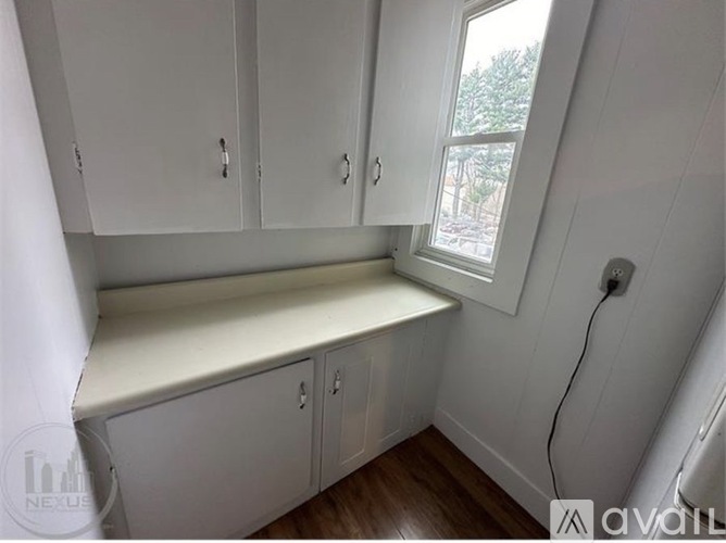 A white cabinet with a window is in the room.