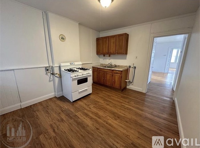 A kitchen with a white stove and wooden cabinets.