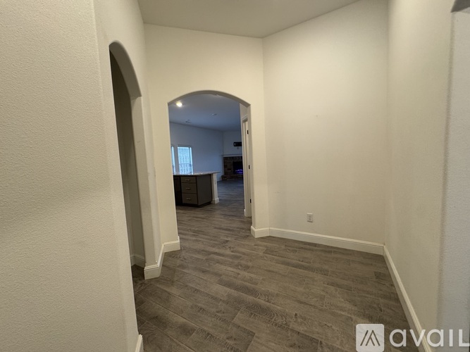A room with a grey carpet and a white wall with a logo on it.