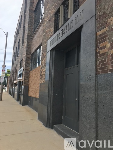 A brick building with a black door and windows.