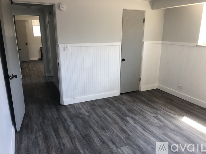 A room with a grey floor and white walls.